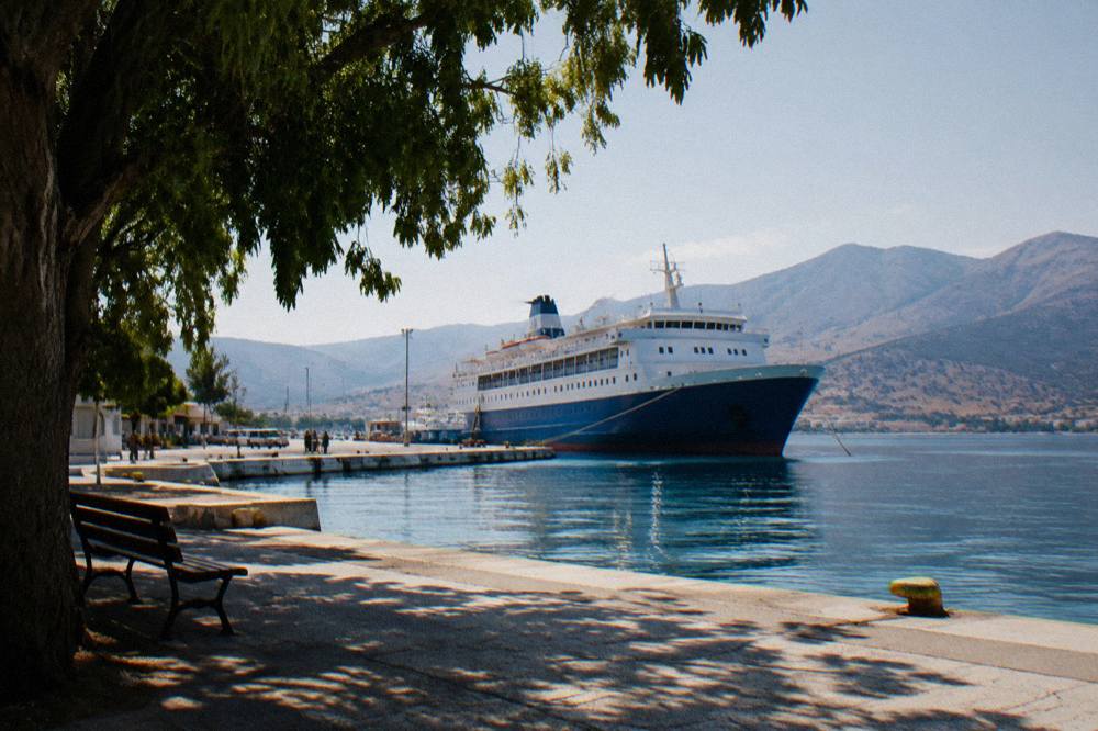 An overnight ferry moored at a Greek island port in the early morning light