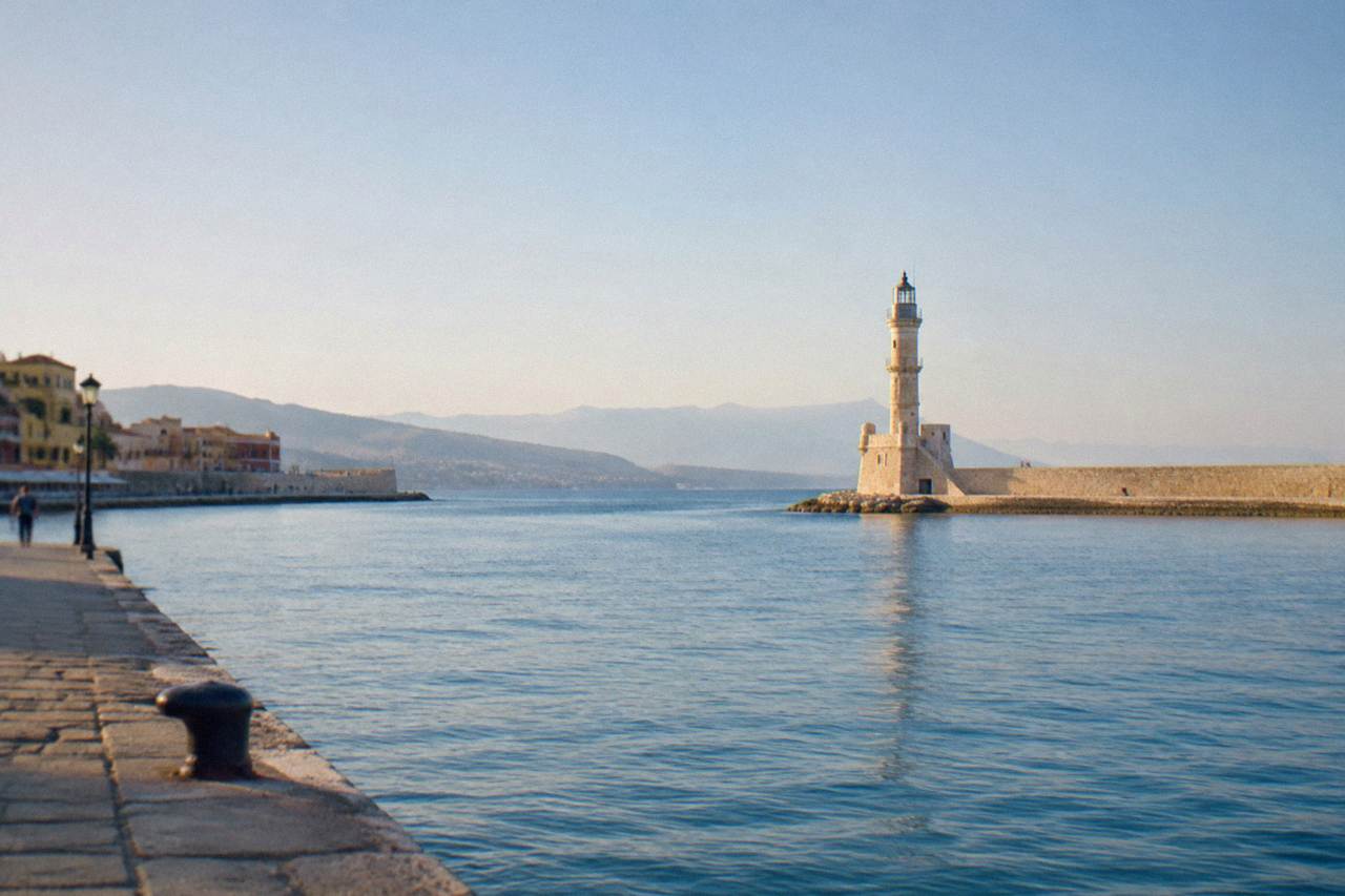 The Venetian lighthouse of Chania standing at the end of the harbour mole under a clear sky