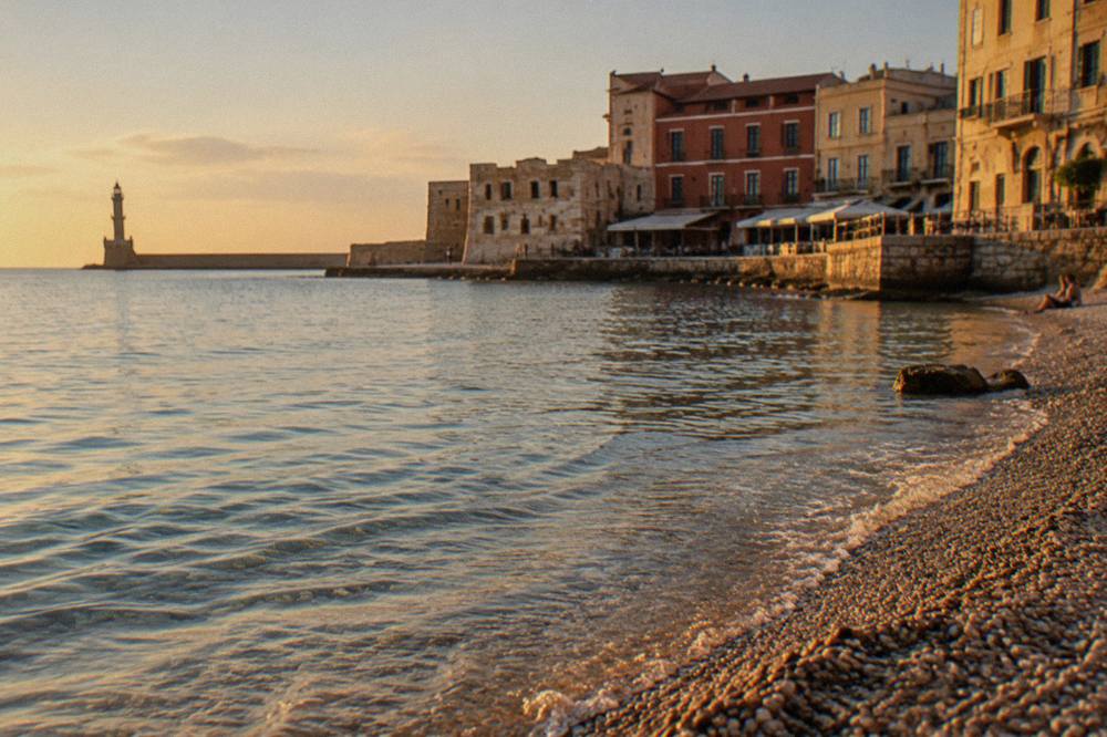 A quiet pebble beach with clear shallow water on the coast near Chania
