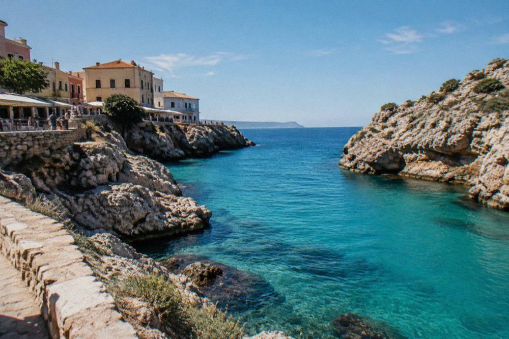 Clear turquoise water filling a narrow cove framed by pale rocky cliffs near Chania
