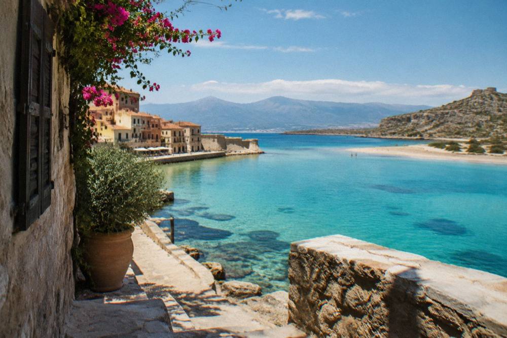 A turquoise lagoon ringed by sand and rocky hills on the coast of western Crete