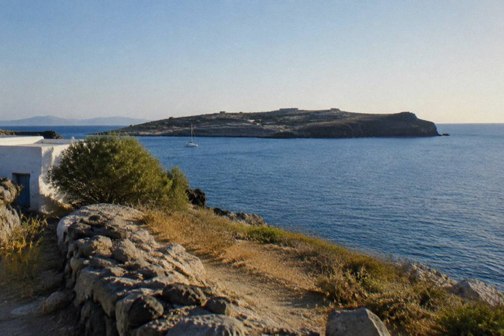 A view across a bay toward a low peninsula under a clear sky
