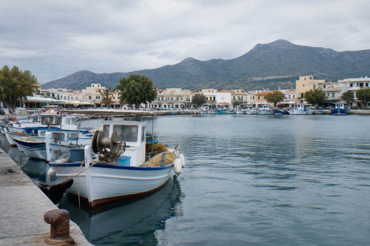 A small harbour town on the north-west coast of Crete with fishing boats moored along a quiet quay