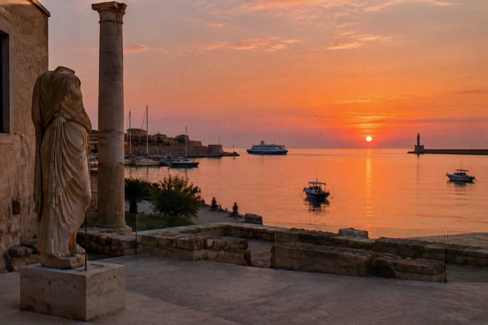 Ferry and boats along the waterfront near Chania at dusk