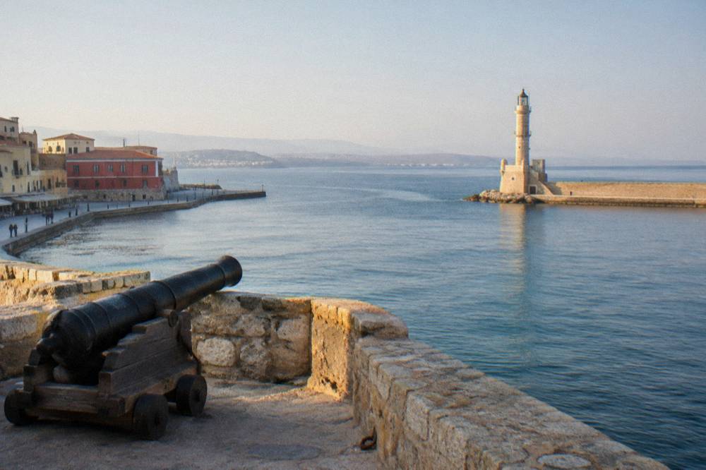 View from the fortress platform across the harbour entrance channel toward the Chania lighthouse