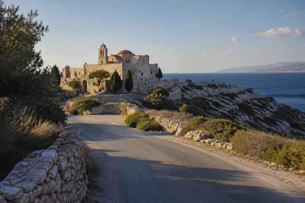 A narrow paved road curving through low rocky scrub on the Akrotiri peninsula