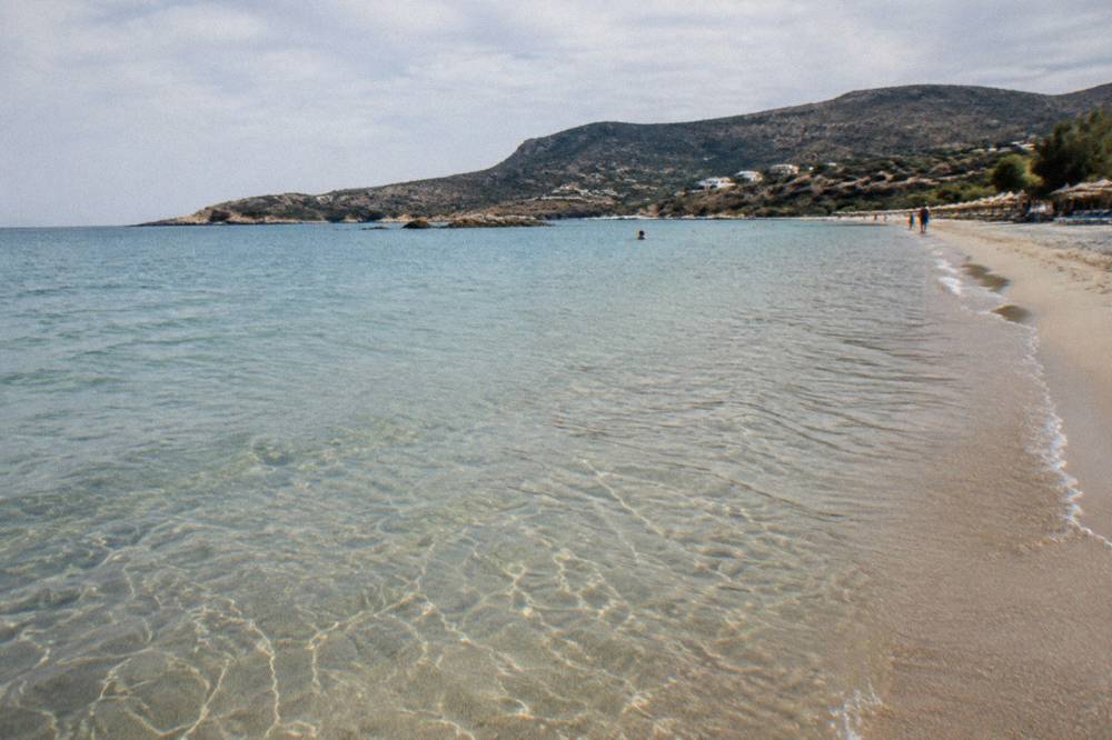 Clear shallow water over sand with gentle ripples, seen from the water's edge