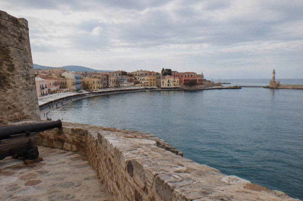 The curve of the Venetian Harbour waterfront seen from the fortress walls in late afternoon light