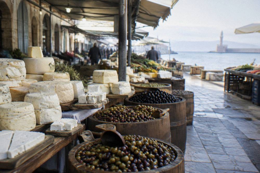Cheese and olive stalls with barrels of olives and trays of Cretan cheese