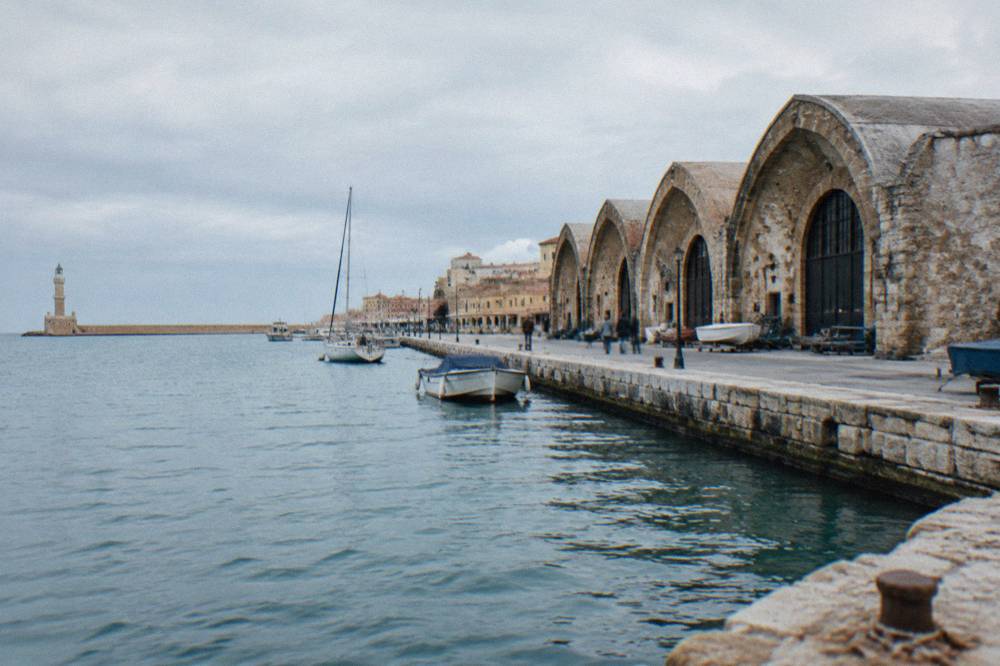 The row of arched Neoria shipyard halls at the eastern end of the Venetian Harbour