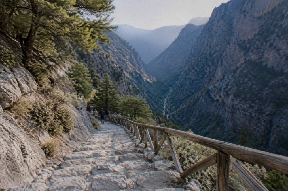 A stone stairway descending from a plateau into a deep mountain gorge