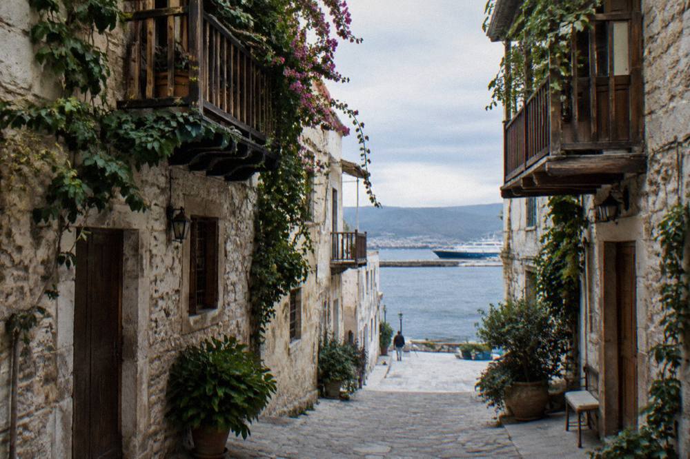 Narrow stone lanes of Chania Old Town with wooden balconies and hanging vines