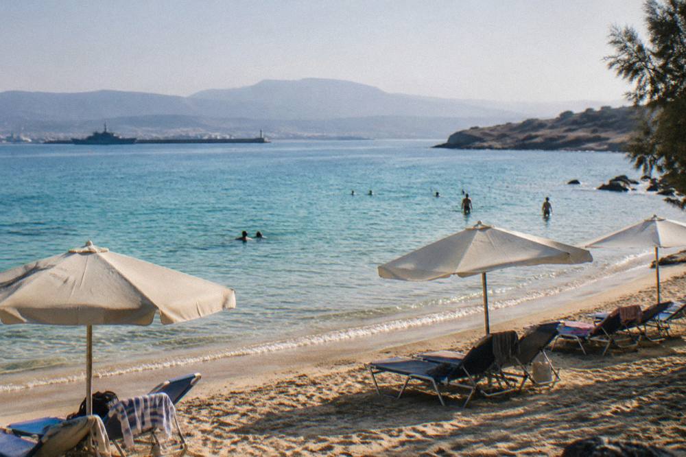 Sunbeds and turquoise shallows at a sandy beach on the Akrotiri peninsula near Chania