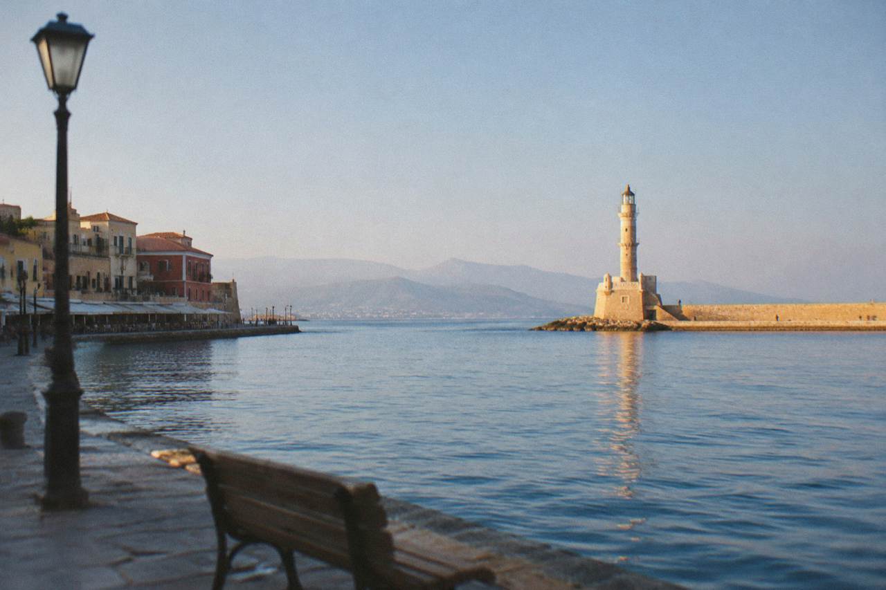 The Venetian Harbour of Chania with the lighthouse at the end of the breakwater under a clear sky
