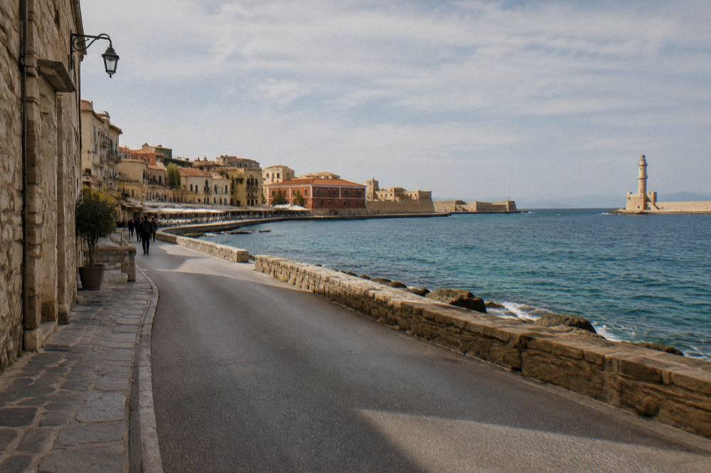 A coastal road curving along a shoreline with blue water below
