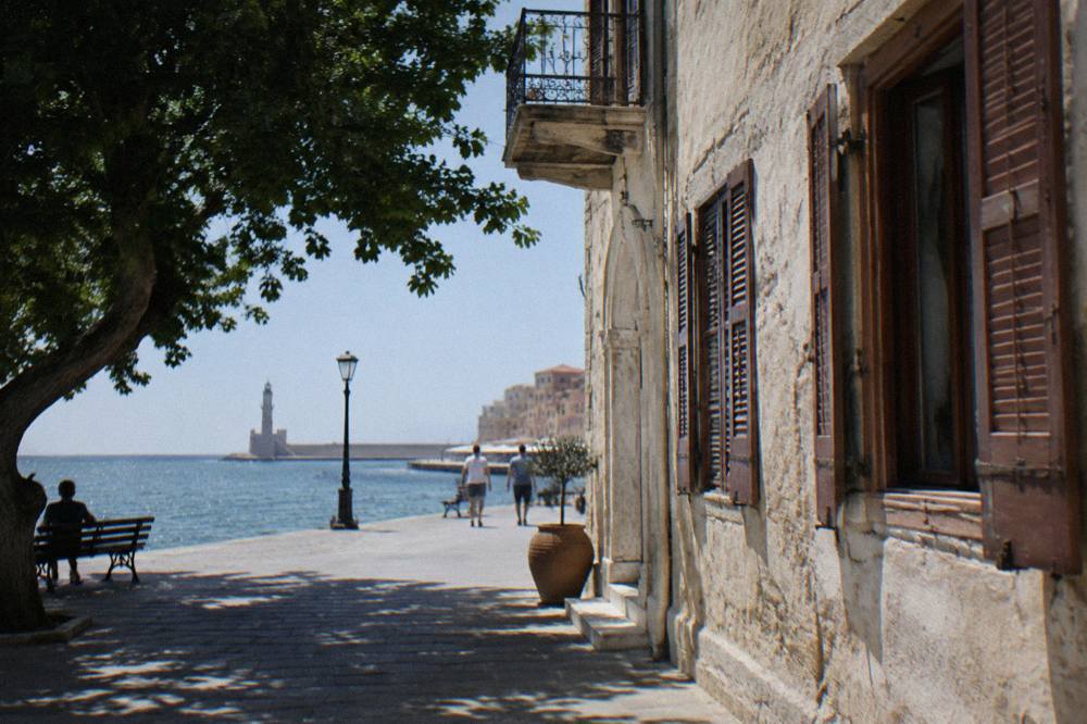 A restored historic building facade with wooden shutters near Chania Venetian Harbour