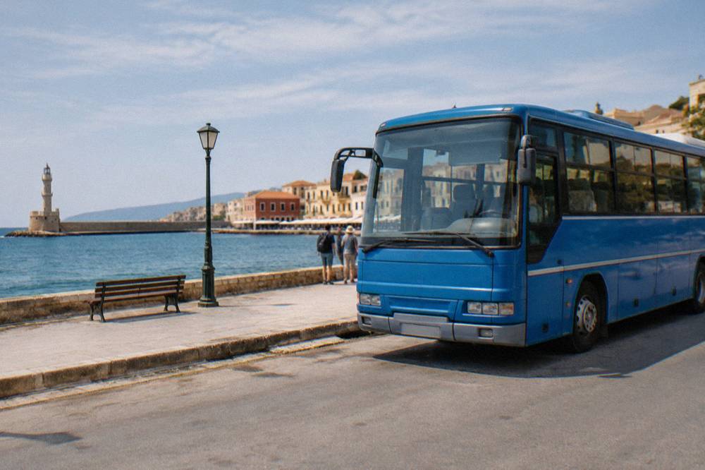A blue KTEL regional bus parked at a roadside stop in Crete under a clear sky
