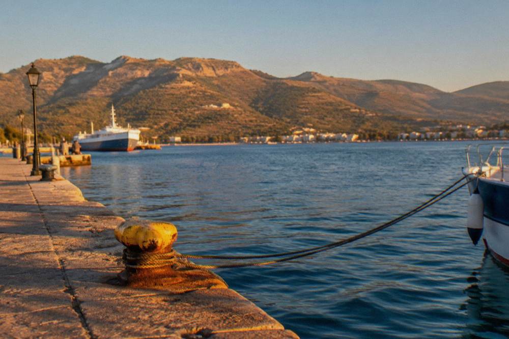 Sunlit hills above Souda Bay with olive groves and a clear sky typical of a Chania summer day