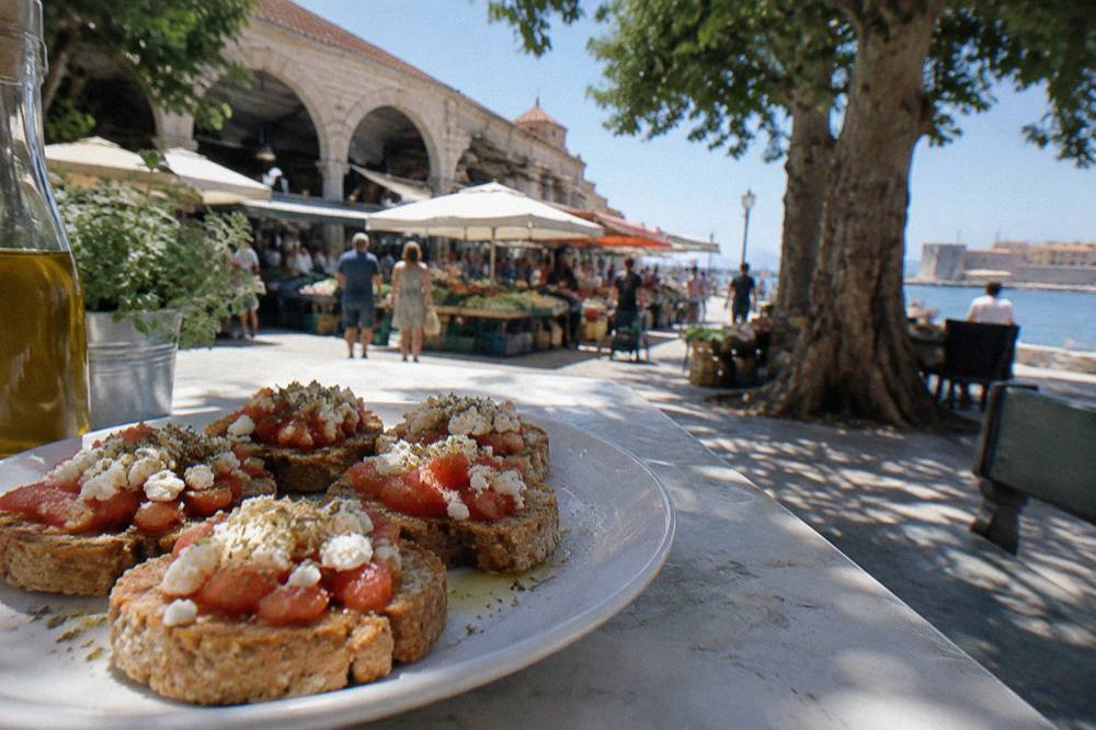 Barley rusks topped with tomato, cheese and olive oil arranged on a plate