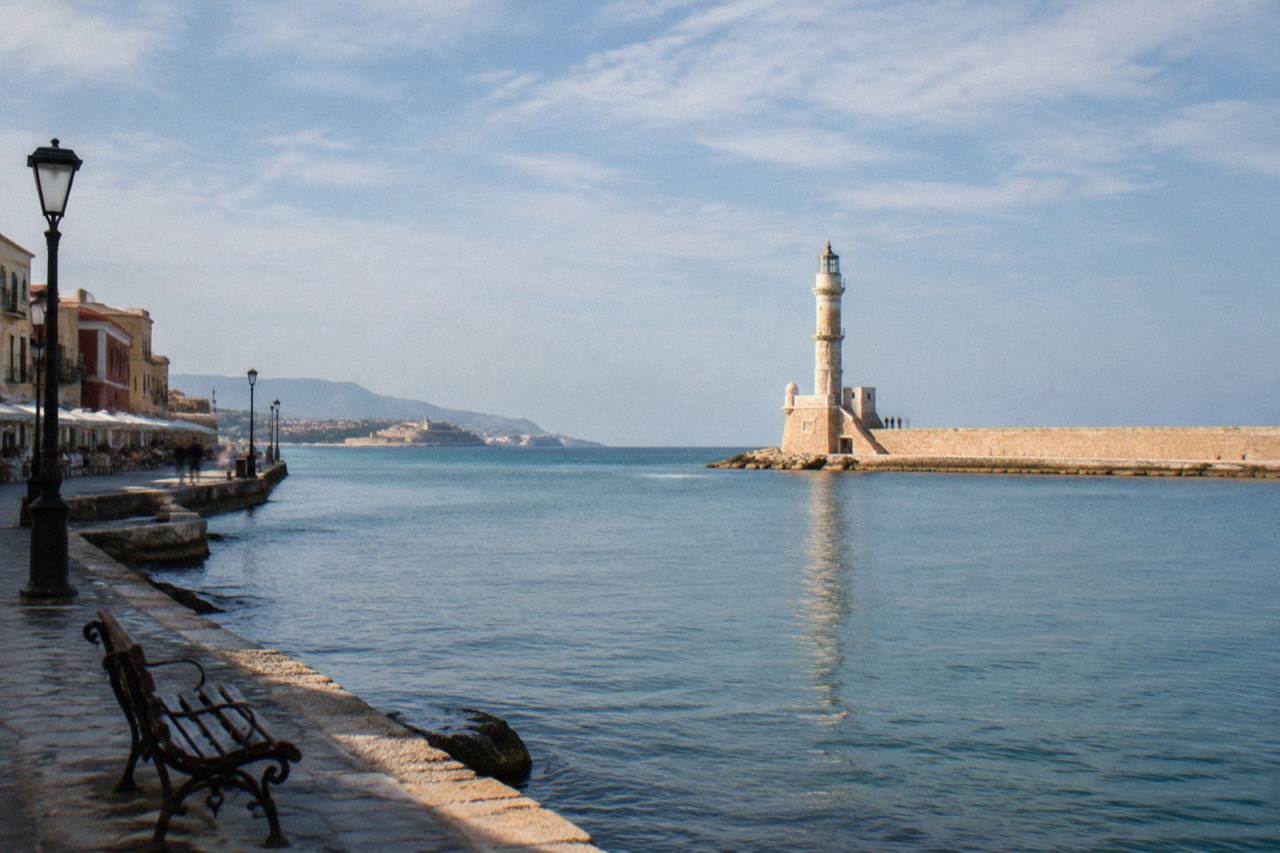 The Venetian Harbour of Chania with the lighthouse at the end of the breakwater on a bright morning