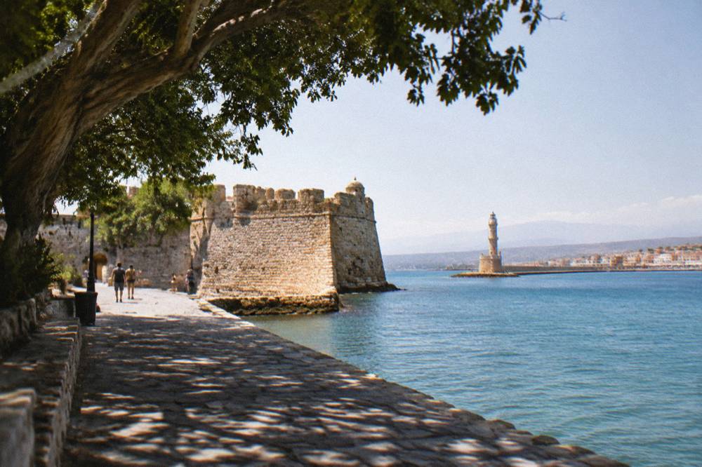 Firka Fortress walls at the entrance of Chania harbour with stone ramparts in warm light