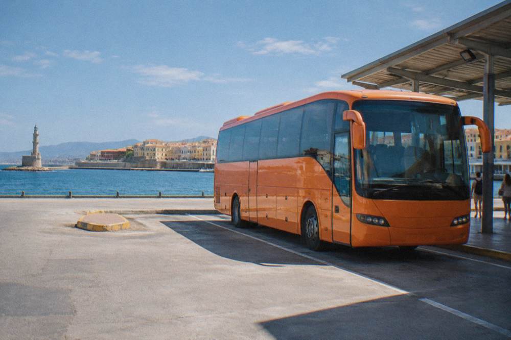 Orange KTEL intercity bus parked at a station in Chania