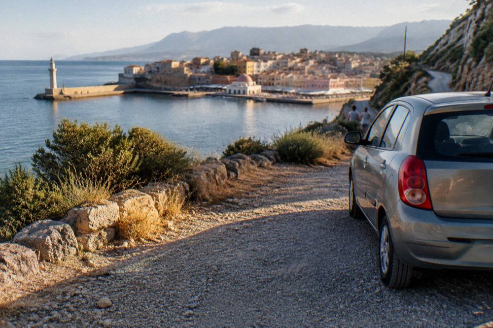 Rental car parked on a gravel verge beside a Cretan mountain road