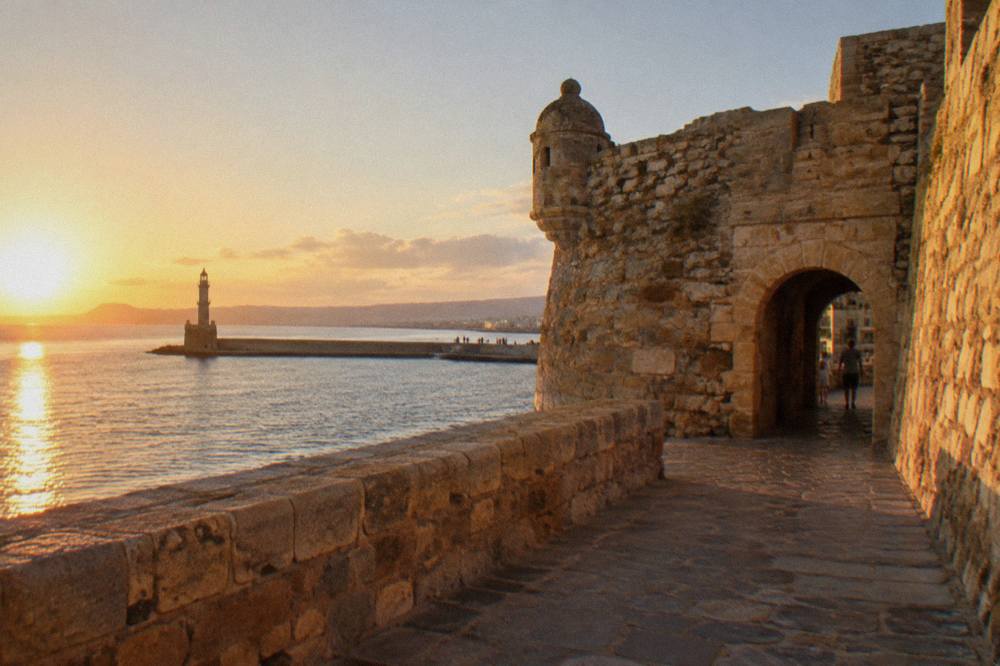 Stone fortress walls at the entrance to the old harbour in Chania
