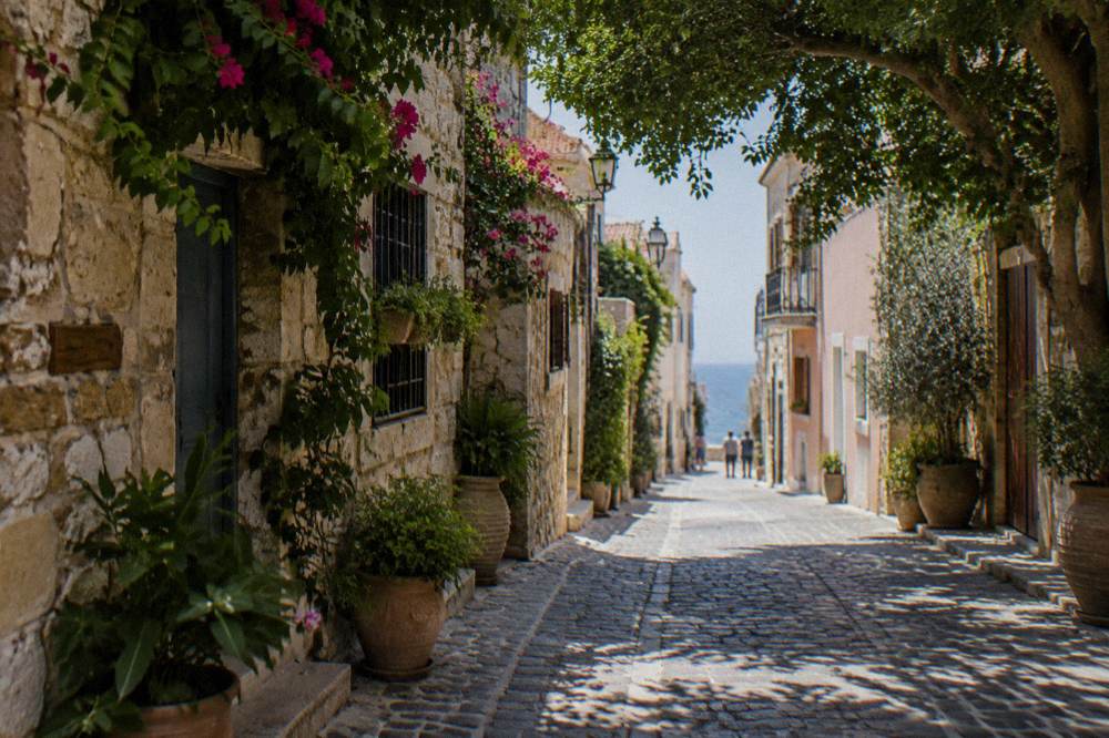 Quiet cobbled lane with old stone houses and hanging plants in Chania Old Town