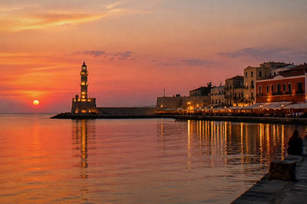 The Venetian Harbour of Chania at dusk with the lighthouse and waterfront buildings lit