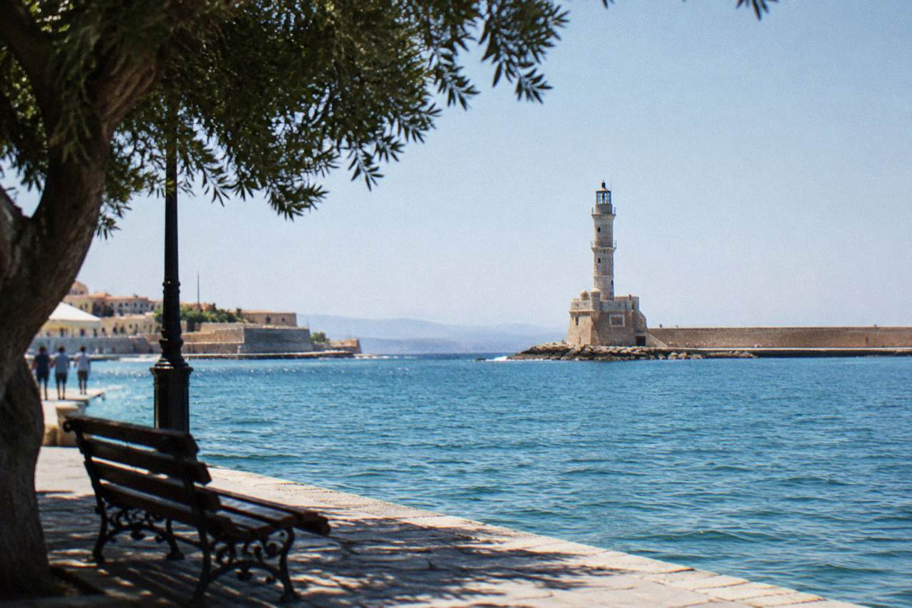 The Venetian Harbour of Chania with the lighthouse at the end of the breakwater under a clear sky