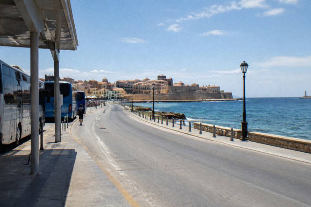 A coastal road in Crete curving along the shore with the sea on one side