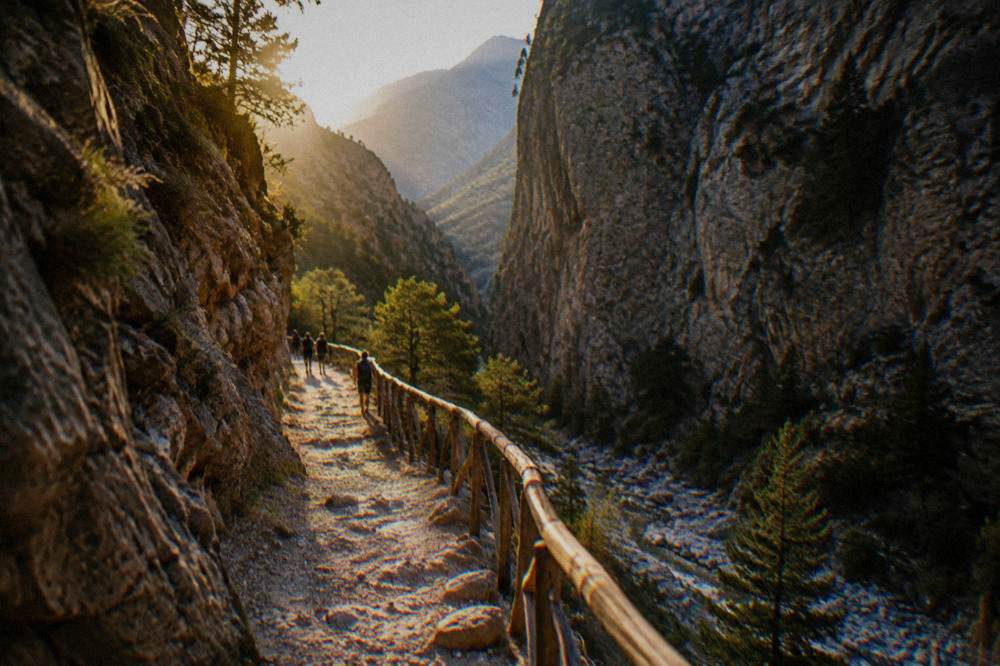 A narrow stone path winding through a gorge with cliffs on both sides