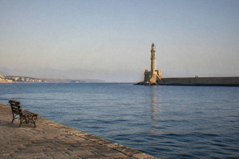 The lighthouse of Chania at the end of the harbour mole under a clear sky