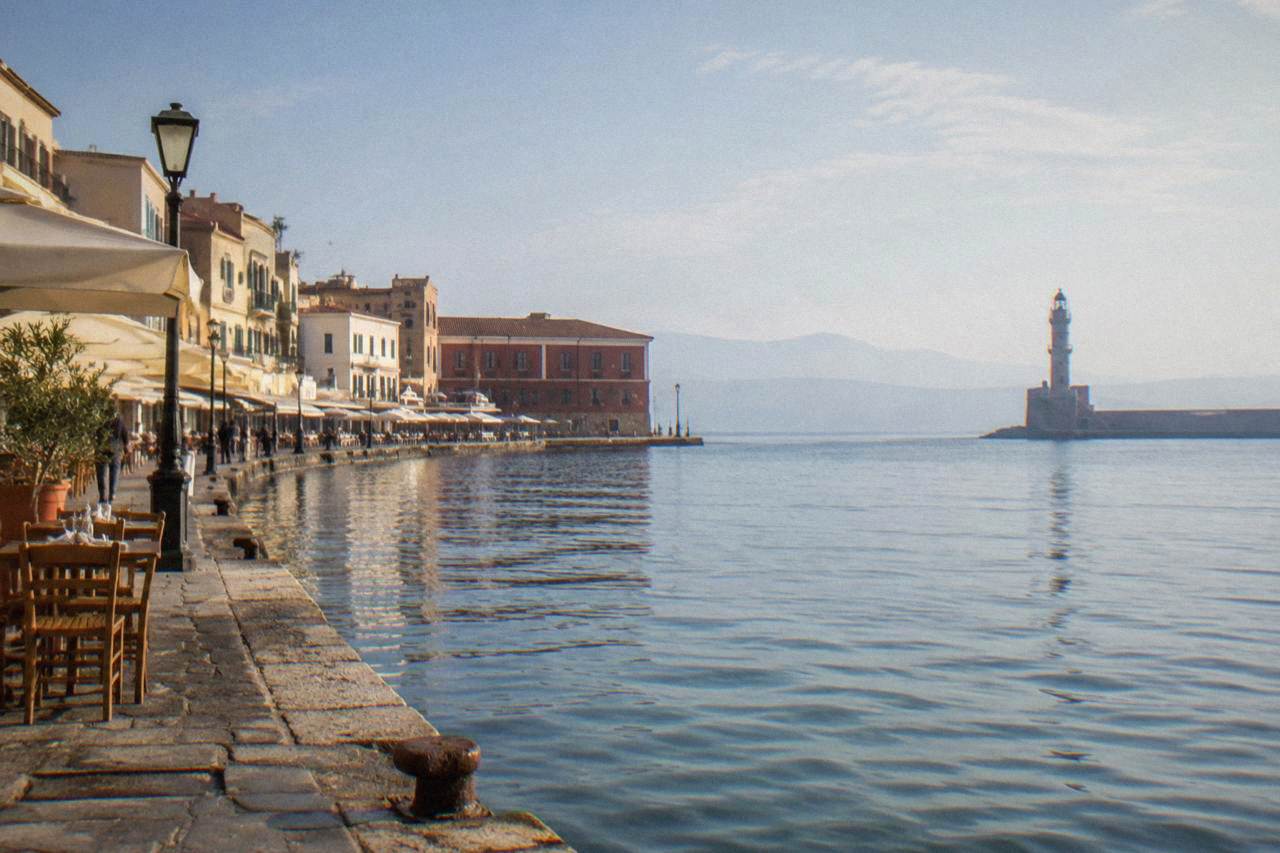 Sunlit stone buildings along the Venetian Harbour in Chania