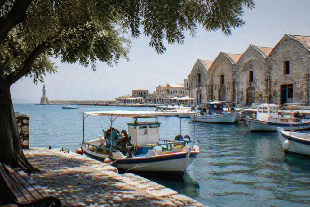 Fishing boats moored beside the Venetian shipyard buildings in Chania