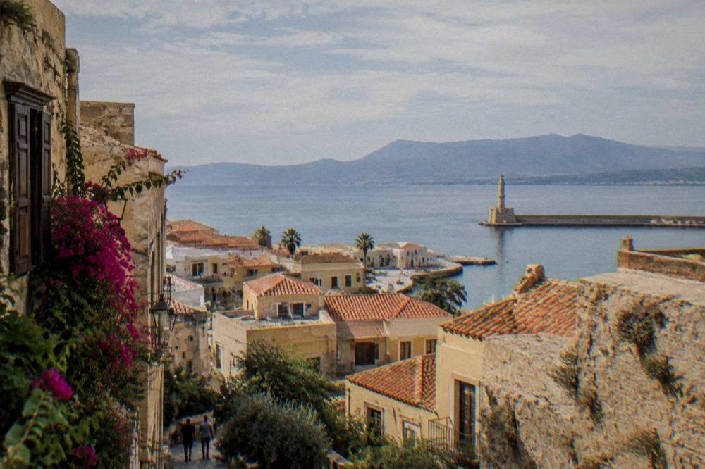 A calm summer morning over Chania rooftops with the sea and distant mountains in the background
