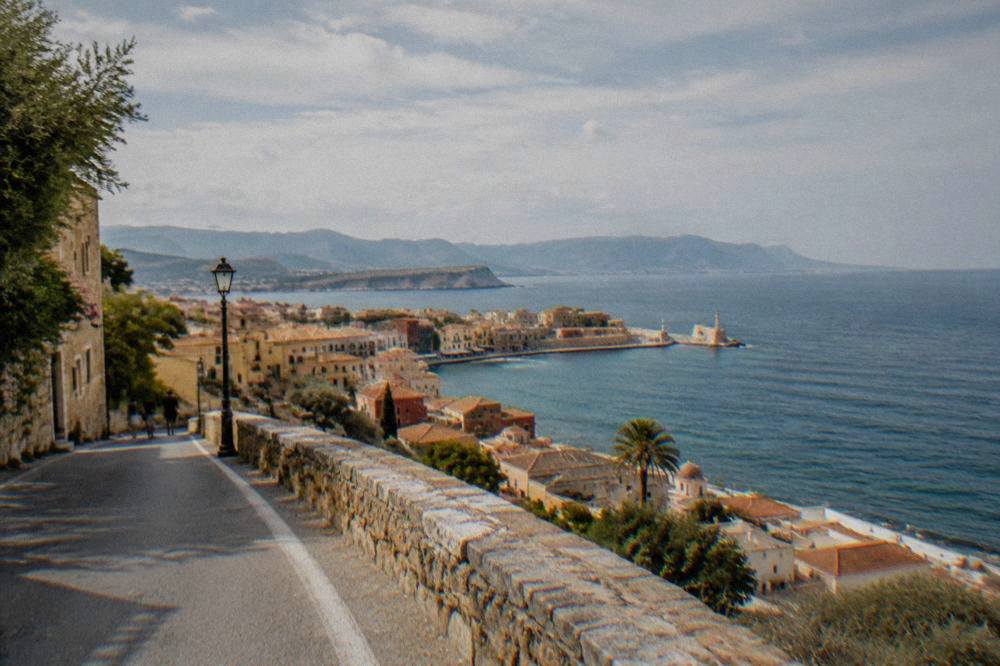 A coastal road above the sea in west Crete with a village visible below