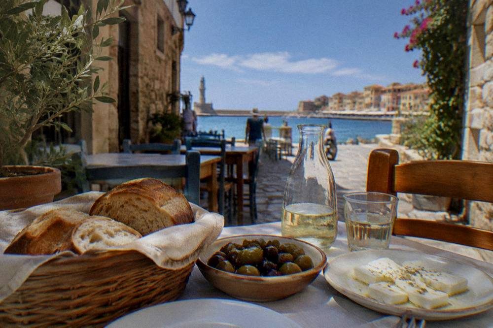 Fresh bread and local olives and cheese on a simple taverna table in a Chania side street