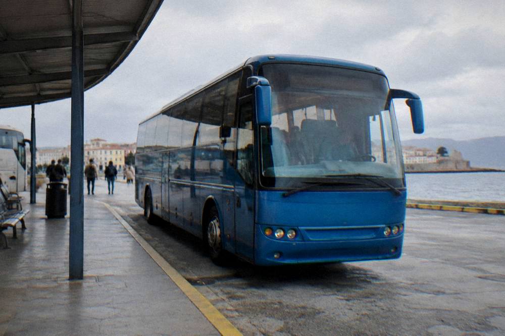 A blue KTEL intercity bus parked at a station platform in Chania
