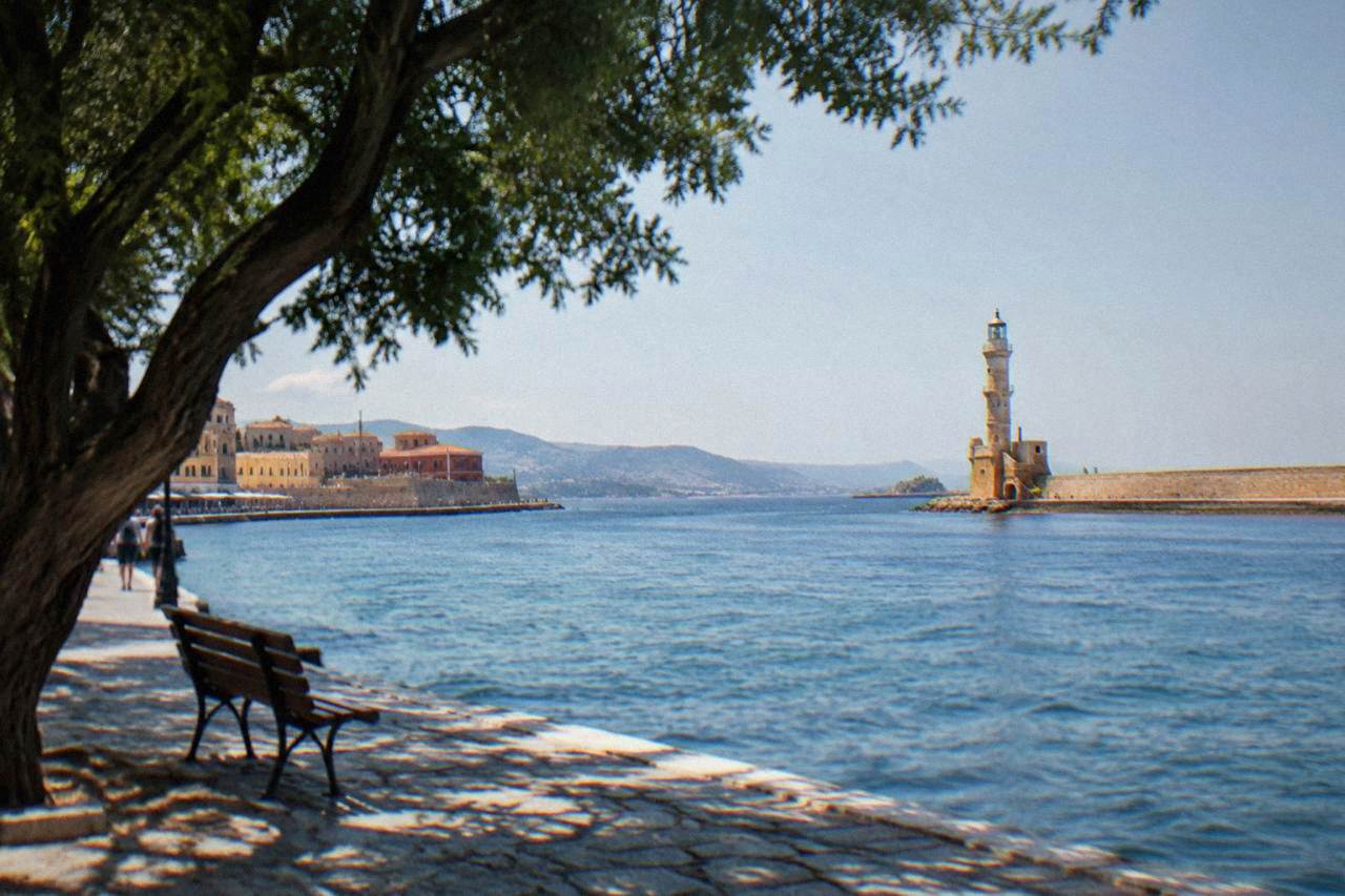 The Venetian Harbour of Chania with its lighthouse at the end of the mole in late afternoon light