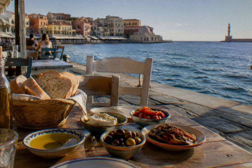 Table setting with bread, olive oil and small dishes at an outdoor taverna