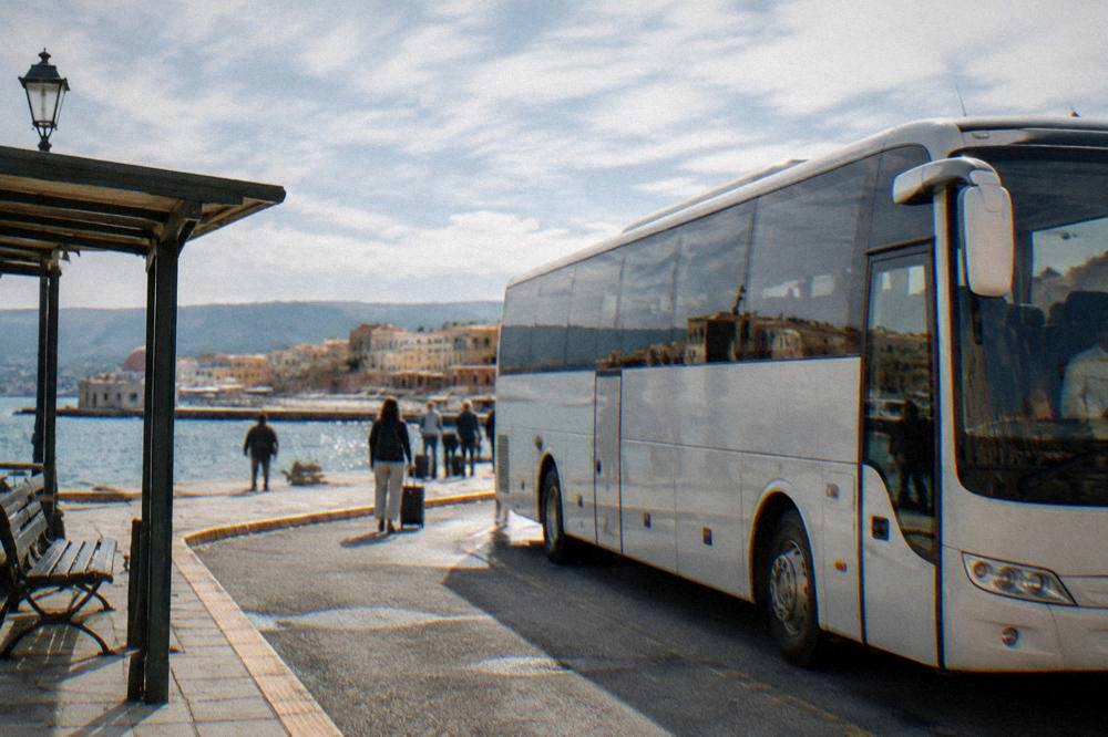 Intercity bus parked at a street-side station in the city