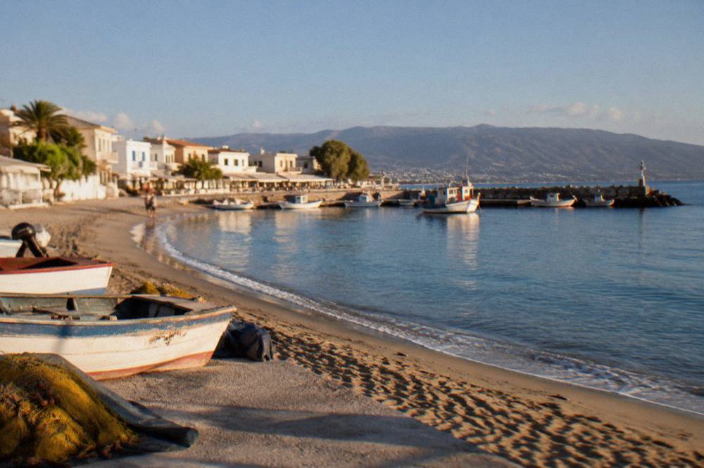 A small fishing harbour and sandy curve with whitewashed houses in Nea Chora, Chania
