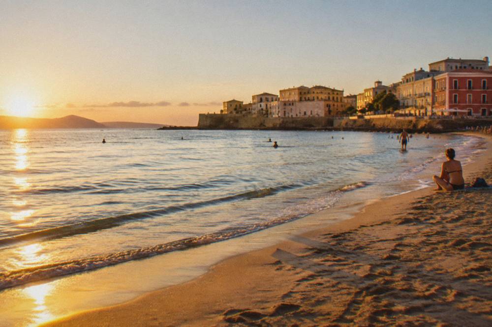 Calm shallow water and sand at Nea Chora beach in Chania in warm evening sun