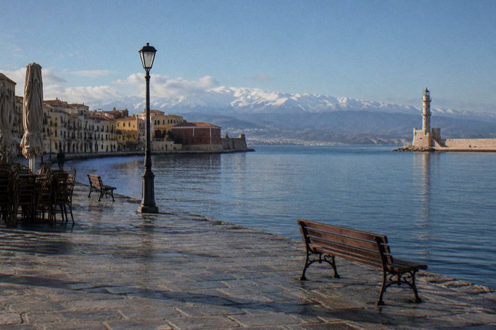 An almost empty harbour promenade in cool winter light in Chania