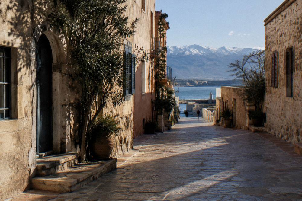 A quiet stone lane of old townhouses in low winter sun in the old town of Chania