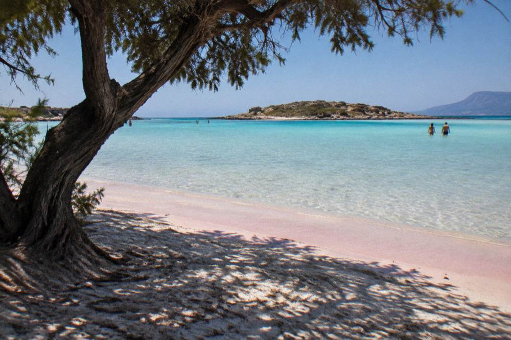 Shallow turquoise water over pale sand and a low islet at Elafonisi beach