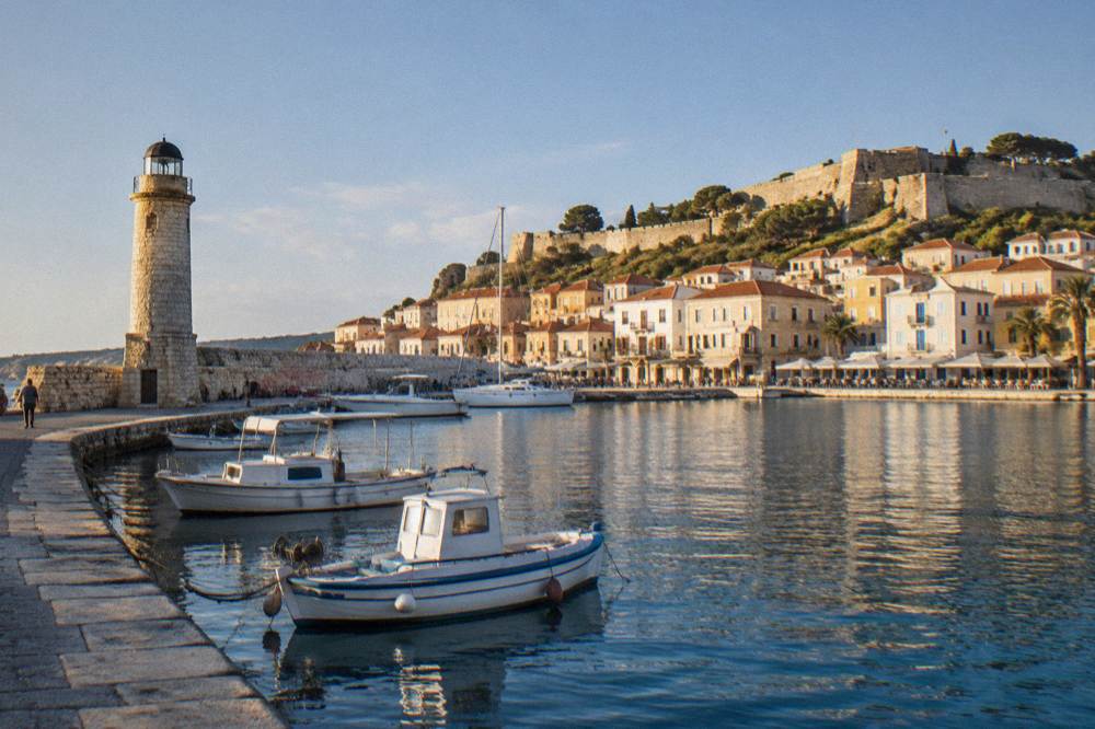 The small Venetian harbour of Rethymno with a lighthouse, moored boats and a fortress above