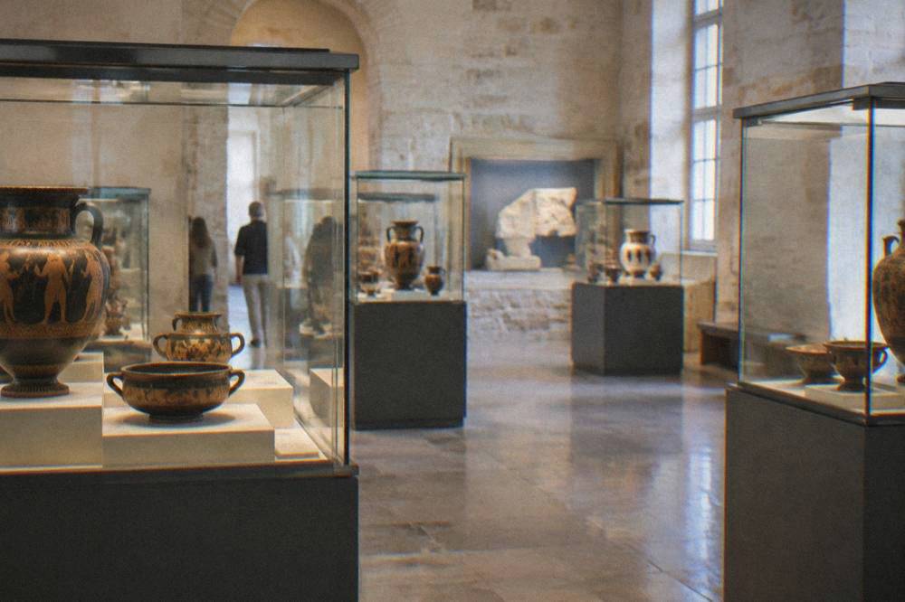 Interior gallery of the Archaeological Museum of Chania with display cases of ancient pottery